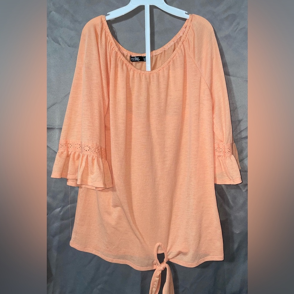 Peach colored women’s blouse size large